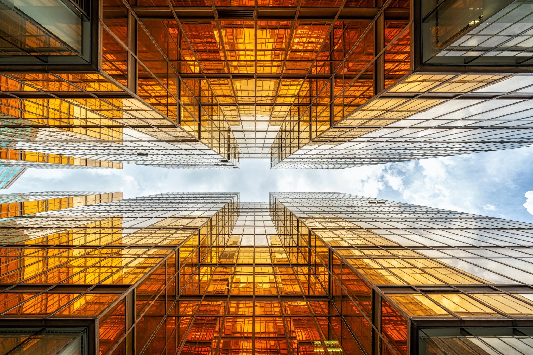 Looking up through reflective modern corporate architecture